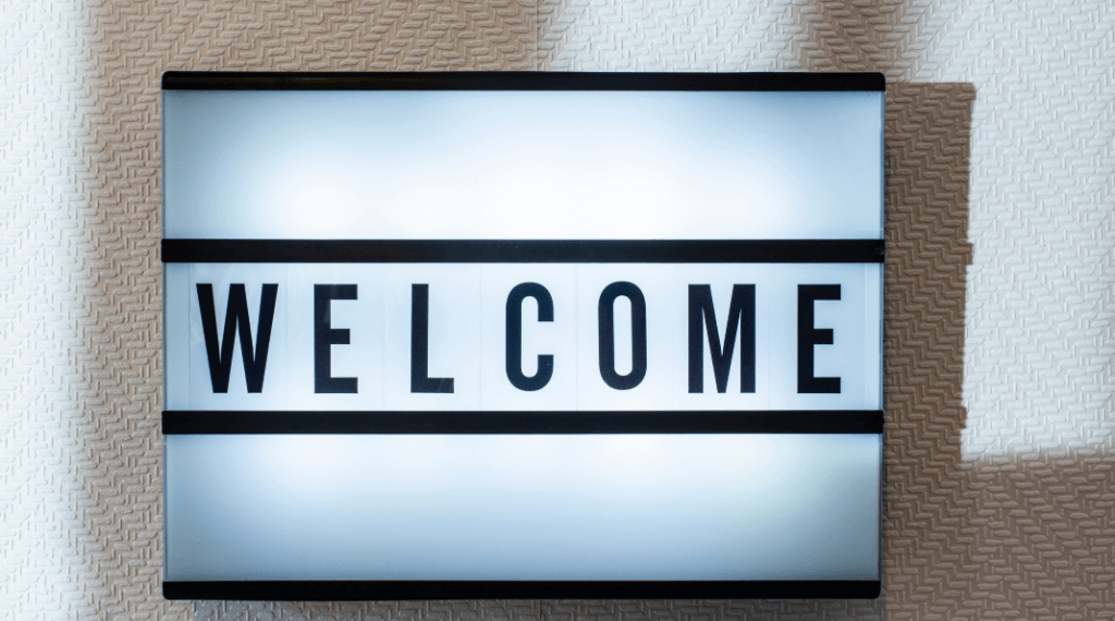 welcome written on white backlit sign